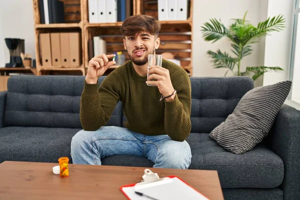 Arab Man Beard Working Depression Holding Pills Water Clueless Confused — Stockfoto