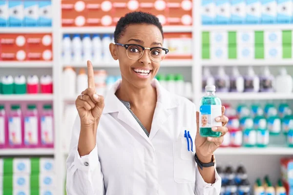 Африканская Американка Работающая Аптеке Держит Сироп Улыбаясь Идеей Вопросом Указывая — стоковое фото