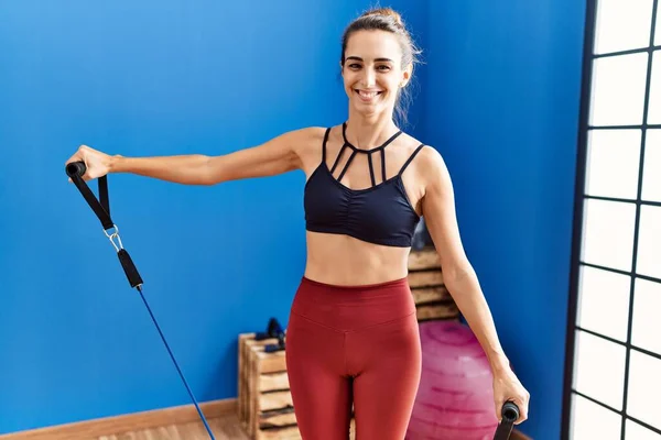 Young Hispanic Woman Smiling Confident Training Using Elastic Band Sport —  Fotos de Stock