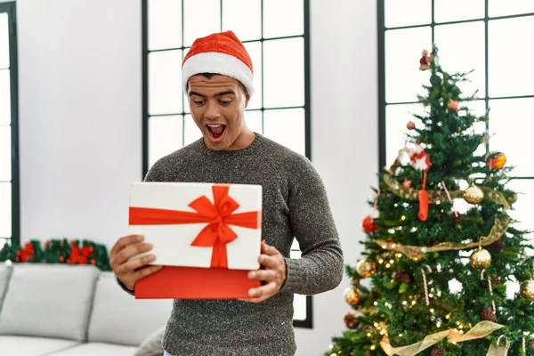 Young Hispanic Man Smiling Confident Holding Box Christmas Decoration Home — Zdjęcie stockowe