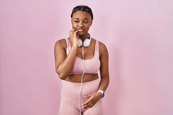 African American Woman Braids Wearing Sportswear Headphones Touching Mouth Hand — Photo
