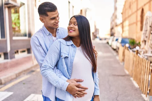 Young Latin Couple Expecting Baby Hugging Each Other Standing Street — Stock fotografie