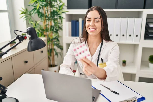 Young Beautiful Hispanic Woman Doctor Using Laptop Holding Pills Clinic — Stock fotografie