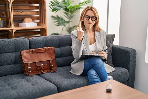 Hispanic Woman Working Consultation Office Showing Middle Finger Impolite Rude — стоковое фото