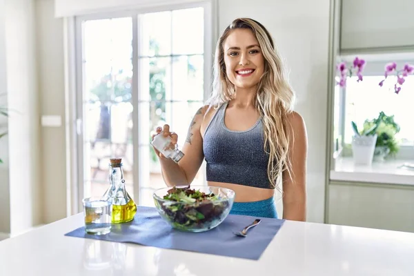 Young Woman Smiling Confident Pouring Salt Salad Kitchen — Stockfoto