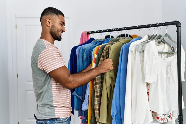 Young Arab Man Holding Shirt Shopping Clothing Store —  Fotos de Stock