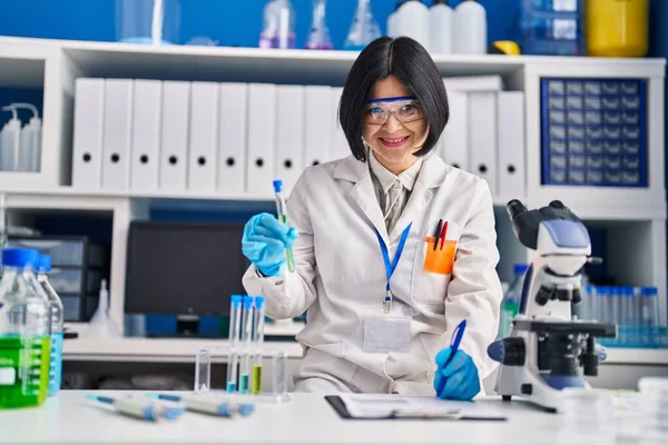 Young Chinese Woman Scientist Holding Test Tube Write Report Document — Stockfoto