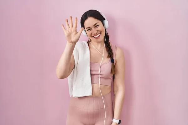 Genç Esmer Kadın Spor Giyiniyor Kulaklık Takıyor Beş Numaralı Parmaklarıyla — Stok fotoğraf