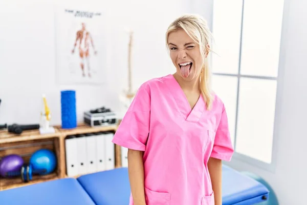 Young Caucasian Woman Working Pain Recovery Clinic Sticking Tongue Out — Stok fotoğraf