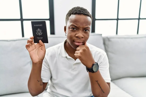 Young African Man Holding United States Passport Serious Face Thinking — Foto Stock