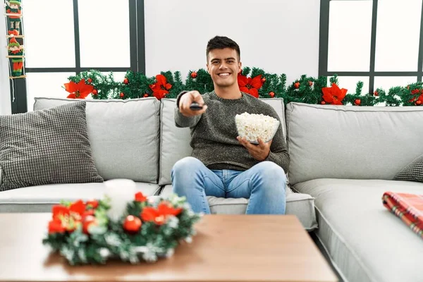 Young Hispanic Man Watching Sitting Sofa Christmas Decor Home — 스톡 사진