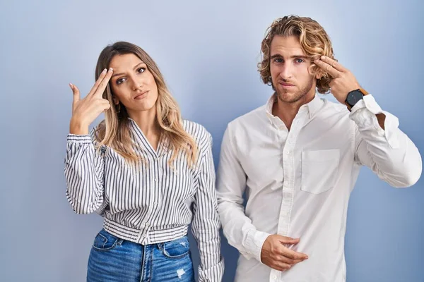Young Couple Standing Blue Background Shooting Killing Oneself Pointing Hand — Stock fotografie