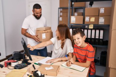 Family smiling confident holding package working at storehouse