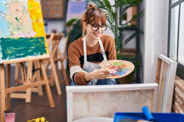 Young woman artist smiling confident drawing at art studio