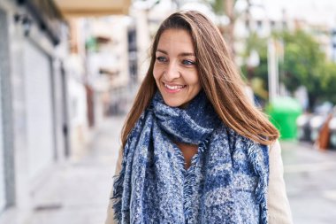 Sokakta kendinden emin gülümseyen genç bir kadın