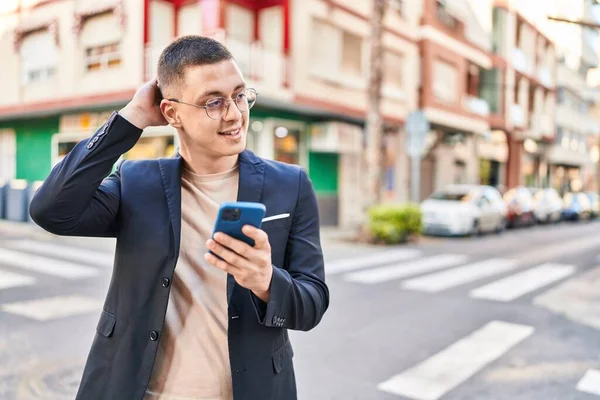 Young Hispanic Man Executive Smiling Confident Using Smartphone Street —  Fotos de Stock