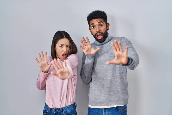 Young Hispanic Couple Standing Together Afraid Terrified Fear Expression Stop — Fotografia de Stock