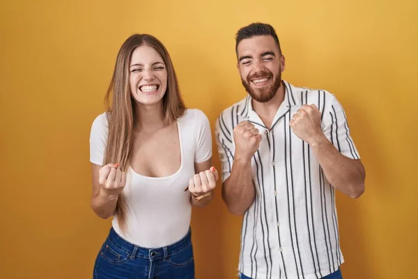 Young Couple Standing Yellow Background Very Happy Excited Doing Winner — 图库照片