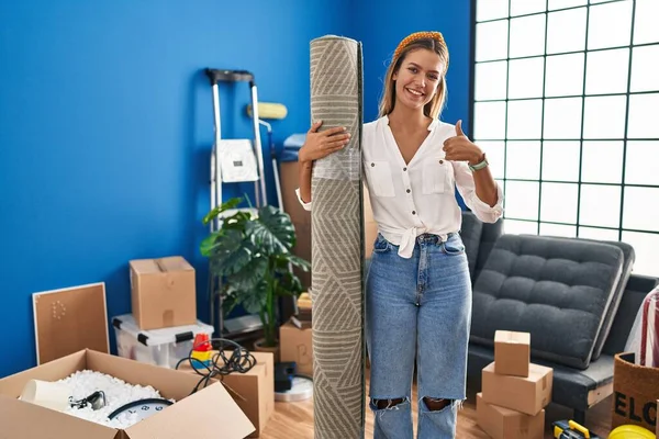 Young Blonde Woman Moving New Home Holding Rug Smiling Happy — Stock Photo, Image