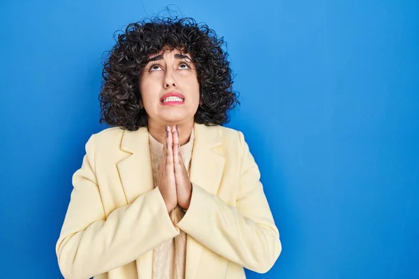 Young Brunette Woman Curly Hair Standing Blue Background Begging Praying — Stock Photo, Image