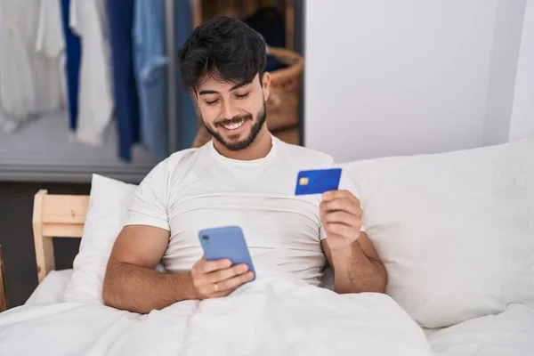 Young Hispanic Man Using Smartphone Credit Card Sitting Bed Bedroom — Photo