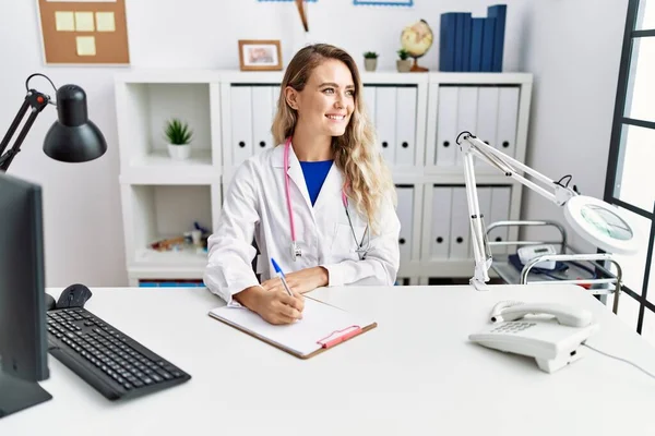 Young Woman Wearing Doctor Uniform Writing Document Clinic — 스톡 사진