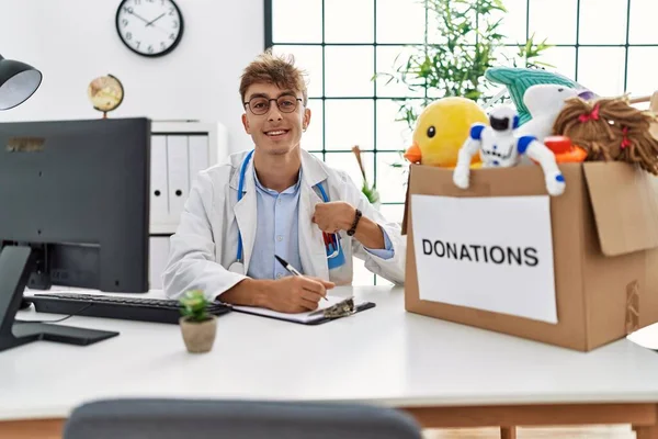 Young Caucasian Doctor Man Working Clinic Toys Donations Box Children — Stockfoto