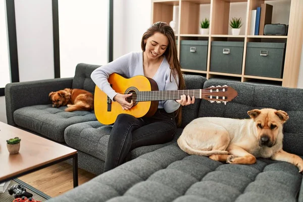 Jovem Hispânica Tocando Guitarra Clássica Sentada Sofá Com Cães Casa — Fotografia de Stock