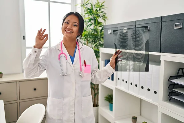 Young Asian Doctor Woman Holding Chest Ray Doing Sign Fingers — Zdjęcie stockowe