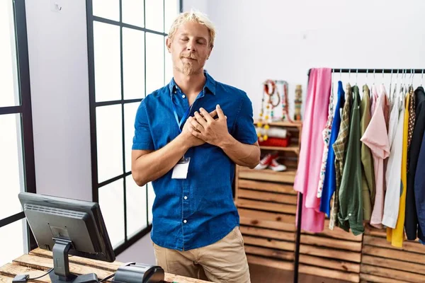 Young Blond Man Working Manager Retail Boutique Smiling Hands Chest — Photo