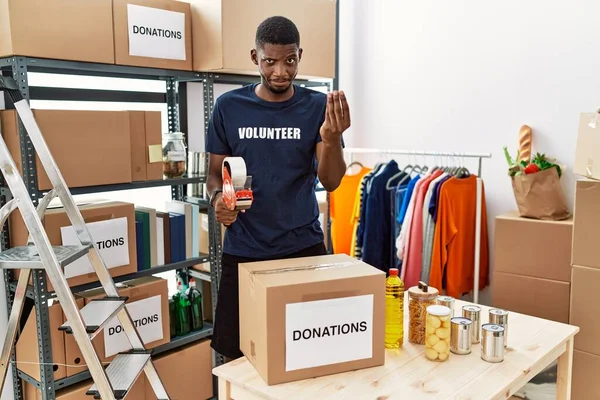 Young African American Volunteer Man Packing Donations Box Charity Doing — Zdjęcie stockowe