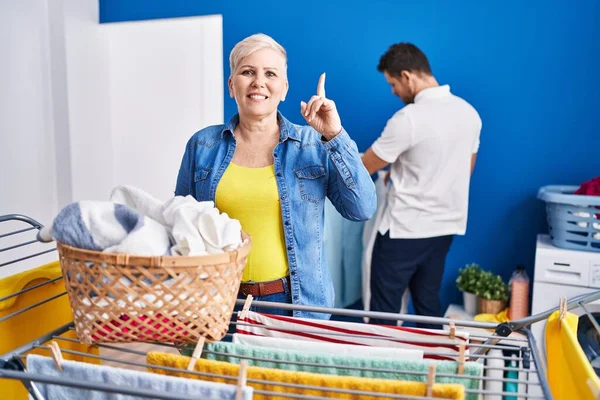 Hispanic Mother Son Hanging Clothes Clothesline Surprised Idea Question Pointing — Stok fotoğraf