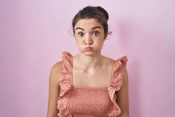 Young Teenager Girl Standing Pink Background Puffing Cheeks Funny Face — Zdjęcie stockowe