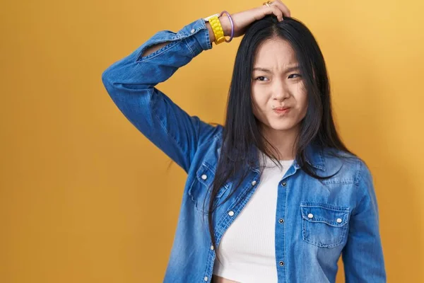 Young Asian Woman Standing Yellow Background Confuse Wondering Question Uncertain — Stock fotografie