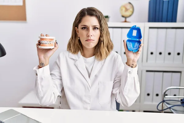 Young Hispanic Woman Working Dentist Clinic Holding Brackets Aligner Depressed — Photo