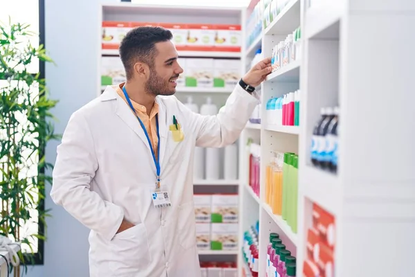 Young Hispanic Man Pharmacist Smiling Confident Holding Product Shelving Pharmacy — Stock Photo, Image