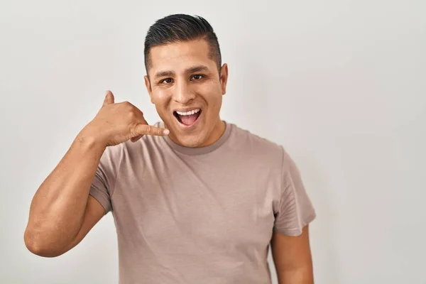 Hispanic Young Man Standing White Background Smiling Doing Phone Gesture — Stock Photo, Image