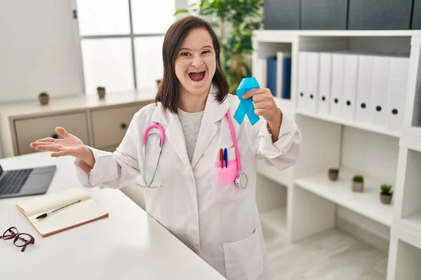 Hispanic Girl Syndrome Wearing Doctor Uniform Holding Blue Ribbon Celebrating — Stock Photo, Image