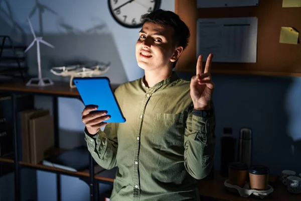 Non Binary Person Using Touchpad Device Night Smiling Looking Camera — 图库照片