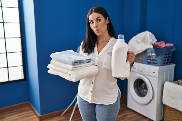 Young Hispanic Woman Holding Clean Laundry Detergent Bottle Making Fish — Stock Photo, Image