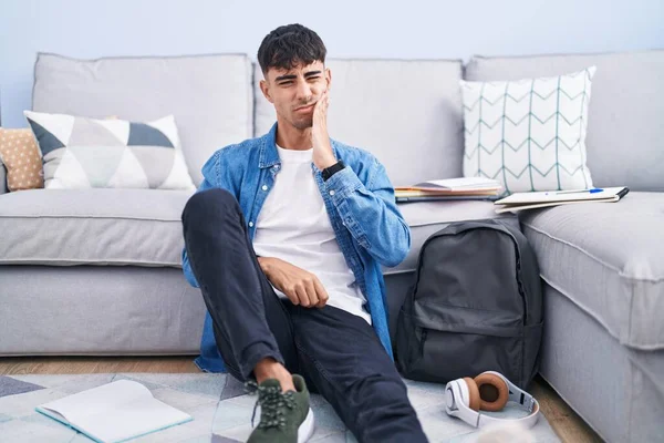 Young Hispanic Man Sitting Floor Studying University Touching Mouth Hand — Zdjęcie stockowe