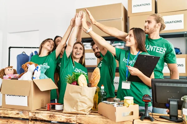 Group Young Volunteers Smiing Happy Hands Raised Charity Center — Stockfoto