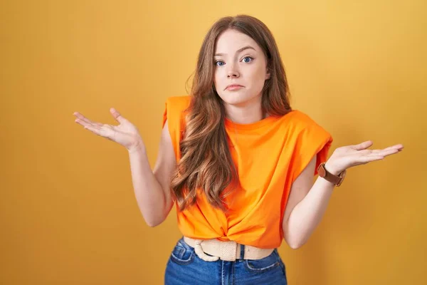 Caucasian Woman Standing Yellow Background Clueless Confused Expression Arms Hands — Zdjęcie stockowe