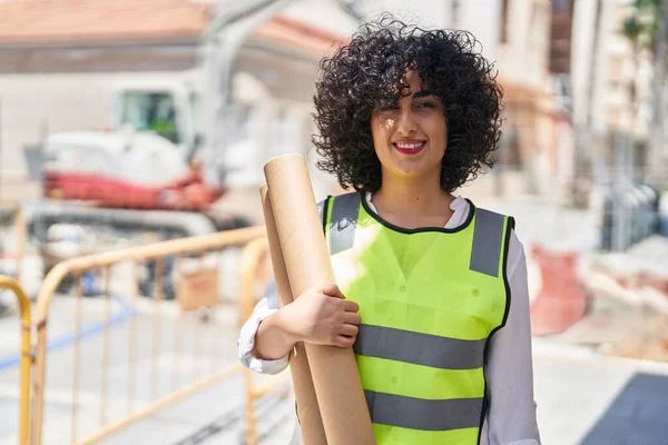 年轻的中东女建筑师带着自信的笑容在街上拿着设计图 — 图库照片