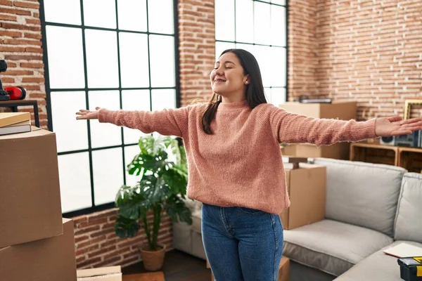 Young Hispanic Woman Standing Arms Open New Home — Stockfoto
