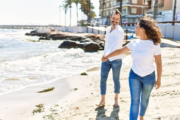 Middle Age Hispanic Couple Smiling Happy Walking Hands Together Beach — Stok fotoğraf