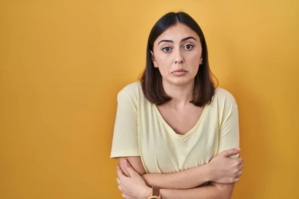 Hispanic Girl Wearing Casual Shirt Yellow Background Shaking Freezing Winter — Stock Photo, Image