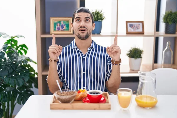 Hispanic Man Long Hair Sitting Table Having Breakfast Amazed Surprised — Stock Photo, Image