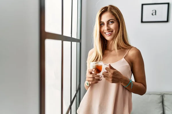 Young Caucasian Girl Smiling Happy Drinking Cup Tea Standing Home — Fotografia de Stock