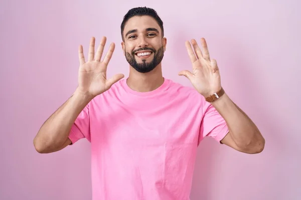 Hispánský Mladý Muž Stojící Nad Růžovým Pozadím Ukazující Ukazující Prsty — Stock fotografie